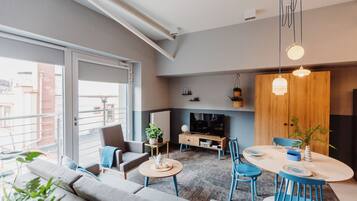 Studio Suite (Sky Blue - 4 people) | Living area | Flat-screen TV