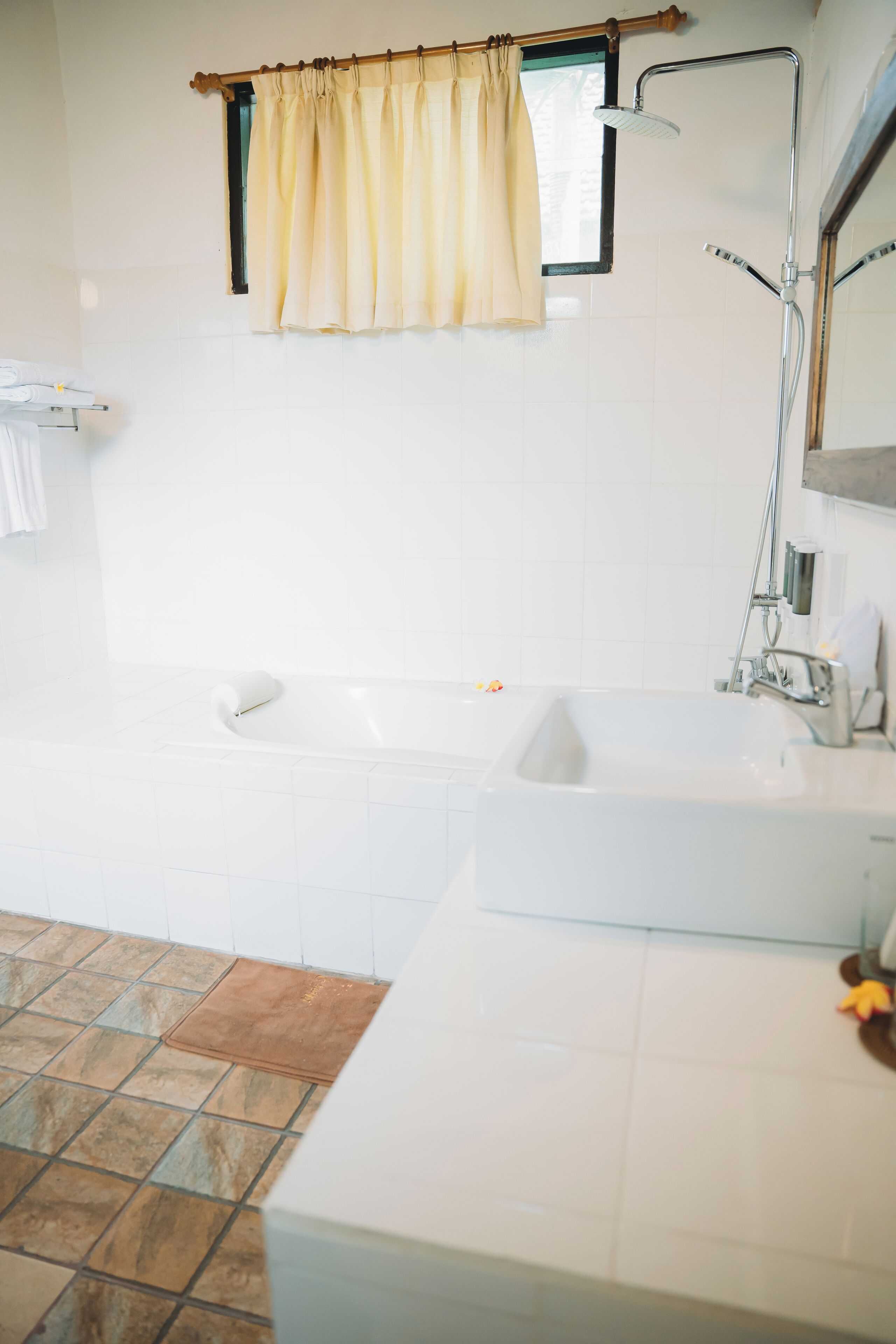A bathroom with a bathtub, a sink, and a shower.