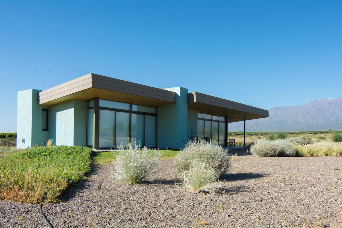 A modern building with large windows and a covered patio area.