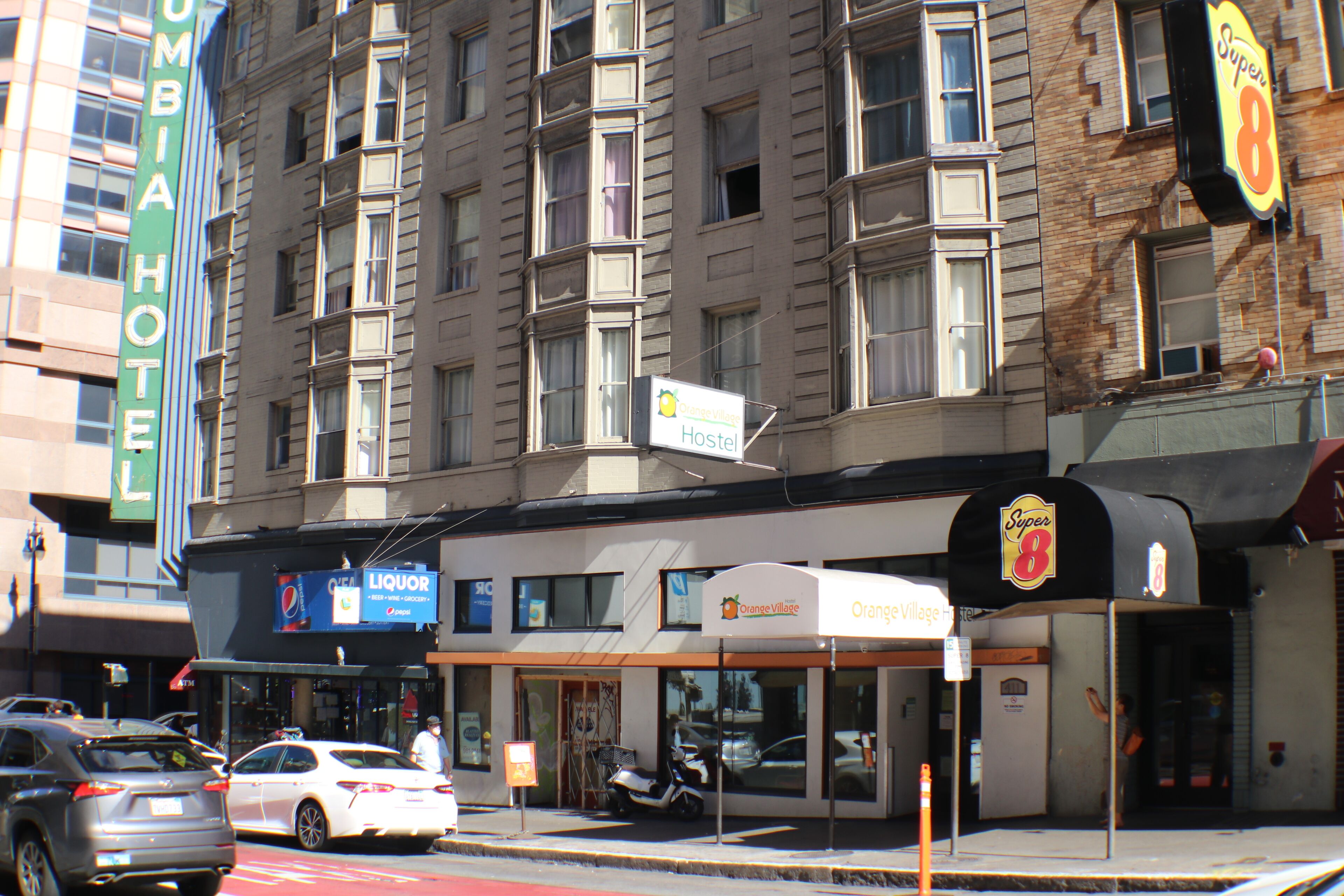 A multi-story hotel with a sign for the Columbia Hotel.