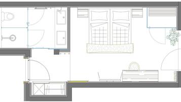 Plano de planta de una habitación de hotel con baño, pequeña cocina, zona de estar y ventana con cortinas.
