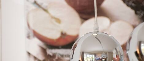A spherical mirror hanging from the ceiling reflecting a room interior.