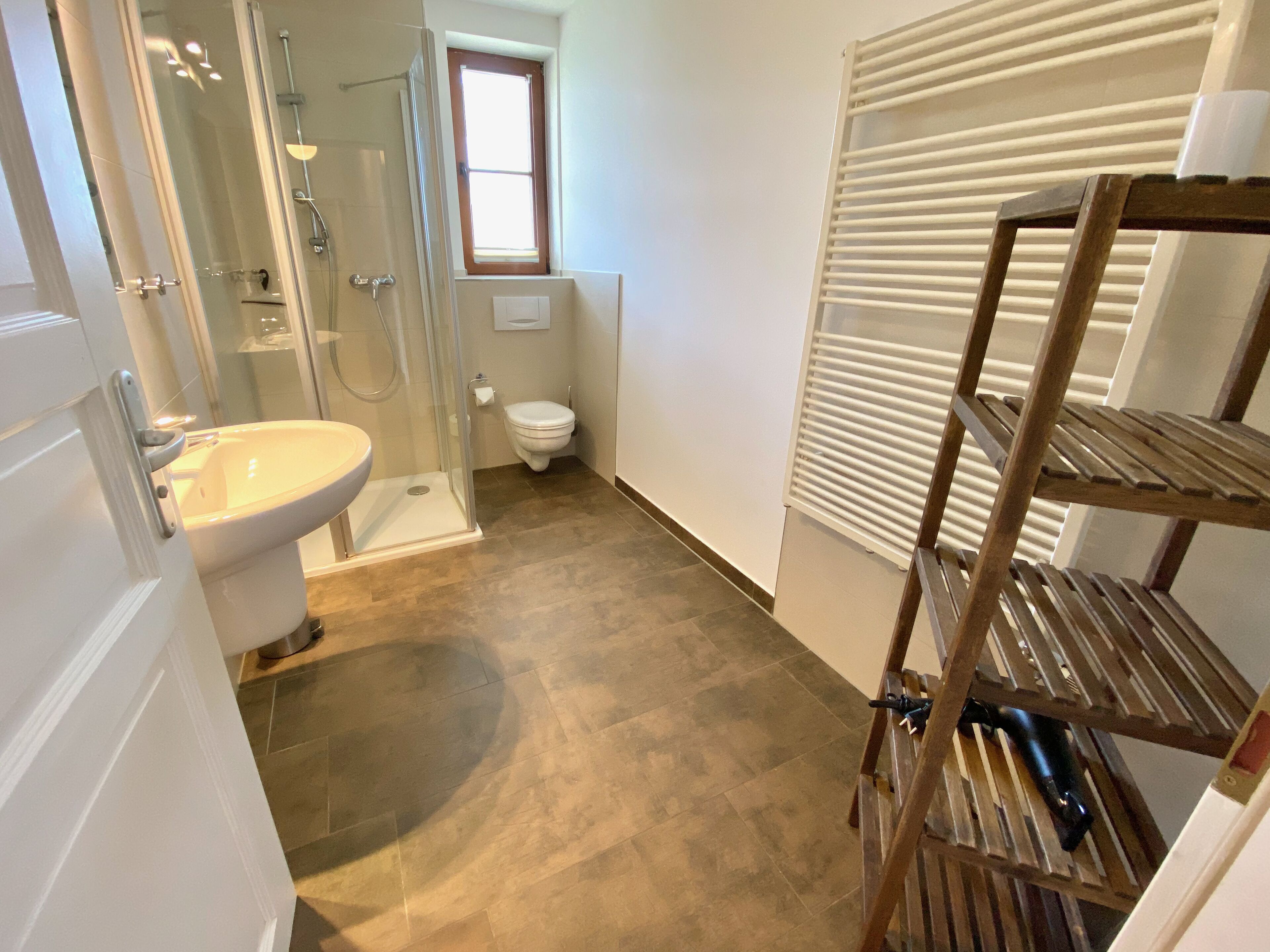 A bathroom with a shower, toilet, and sink.