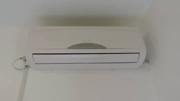 A white air conditioning unit mounted on a wall.