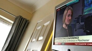 A television screen displaying a news broadcast about the Conservative Conference in Manchester. - Hotel Belmonte (Norwich)