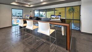 A modern reception area with a reception desk, computer, and seating area.