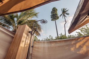 A shower area with a rain showerhead, surrounded by palm trees and a clear sky. - Khwan Beach Resort - Pool Villas and Glamping - Adults Only (Koh Samui)
