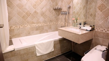 A bathroom with a bathtub, a sink, and a toilet.