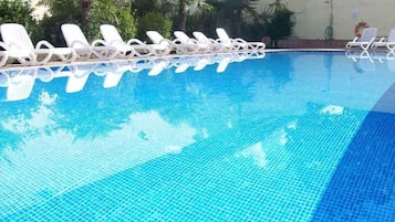 Seasonal outdoor pool, pool loungers