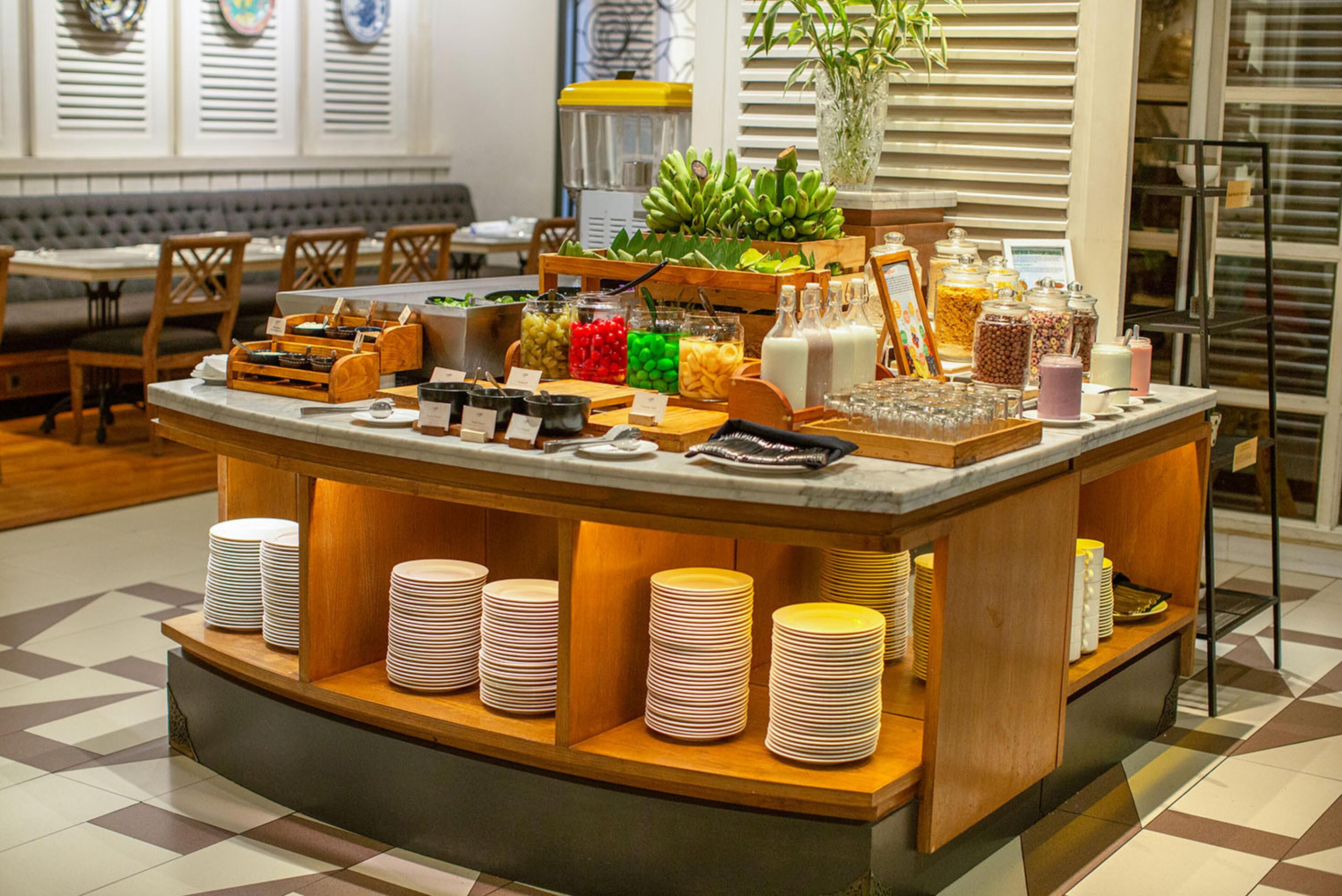 A buffet setup with various food items and condiments.