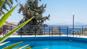 Seasonal outdoor pool, open noon to 8:00 PM, pool umbrellas