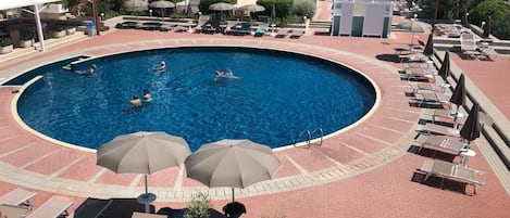 Seasonal outdoor pool, open 9 AM to 8 PM, pool umbrellas, pool loungers