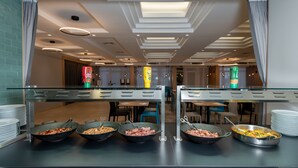 A buffet setup with multiple serving stations, each with a variety of food items. - Hotel Kolovare (Zadar)