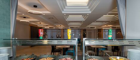A buffet setup with multiple serving stations, each with a variety of food items.