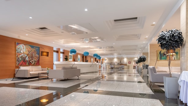 A spacious lobby with a polished marble floor, modern seating areas, and contemporary artwork. - Hotel Kolovare (Zadar)