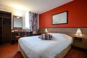 Relax in comfort with a large bed, bedside tables, and a desk for work.