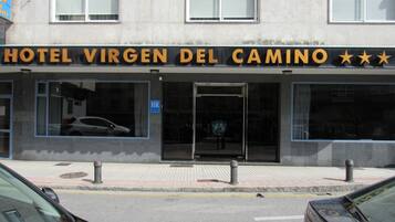 A hotel named 'Hotel Virgen del Camino' with a signboard displaying three stars.