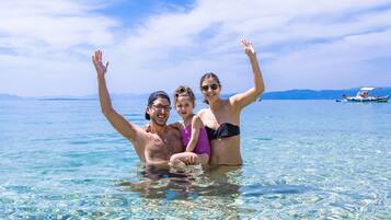 On the beach, white sand, sun-loungers, beach umbrellas