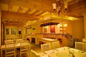 Un restaurante con vigas de madera, mesas y sillas blancas.