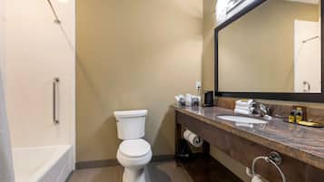 A modern bathroom with a bathtub, toilet, and sink.