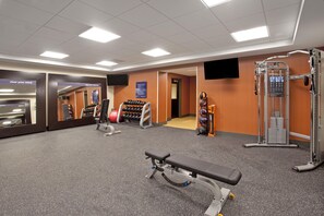 A gym with exercise equipment, a bench, and a treadmill. - Hampton Inn & Suites Minneapolis / Downtown (Minneapolis)