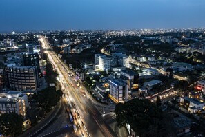 A cityscape at dusk with a busy highway, modern buildings, and illuminated streets. - Airport View Hotel (Accra)