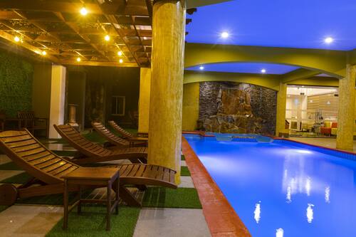 Indoor pool, pool umbrellas, pool loungers