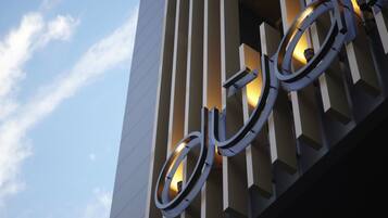 A building facade with a large, illuminated bicycle symbol.