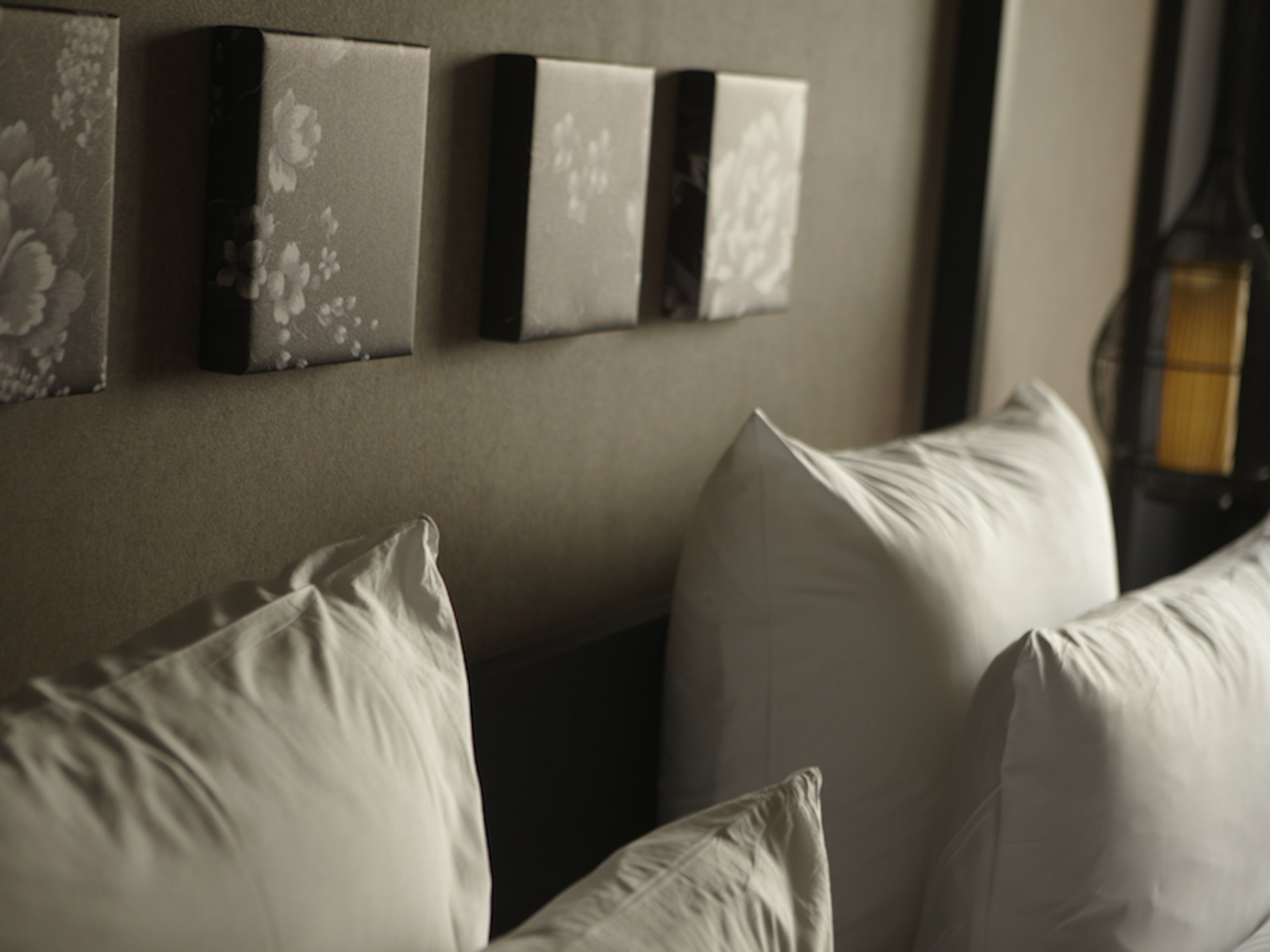A room with a sofa and three wall-mounted picture frames.