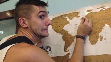 A person pointing at a world map.