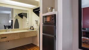 A compact kitchen with a microwave, refrigerator, and a sink with a countertop. - Red Roof Inn & Suites Scottsboro (Scottsboro)