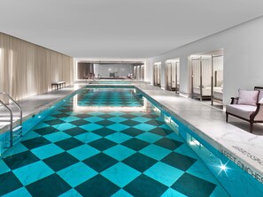 A long indoor swimming pool with a checkered floor pattern, surrounded by seating areas and a spa-like setting. - Baccarat Hotel and Residences New York (New York)