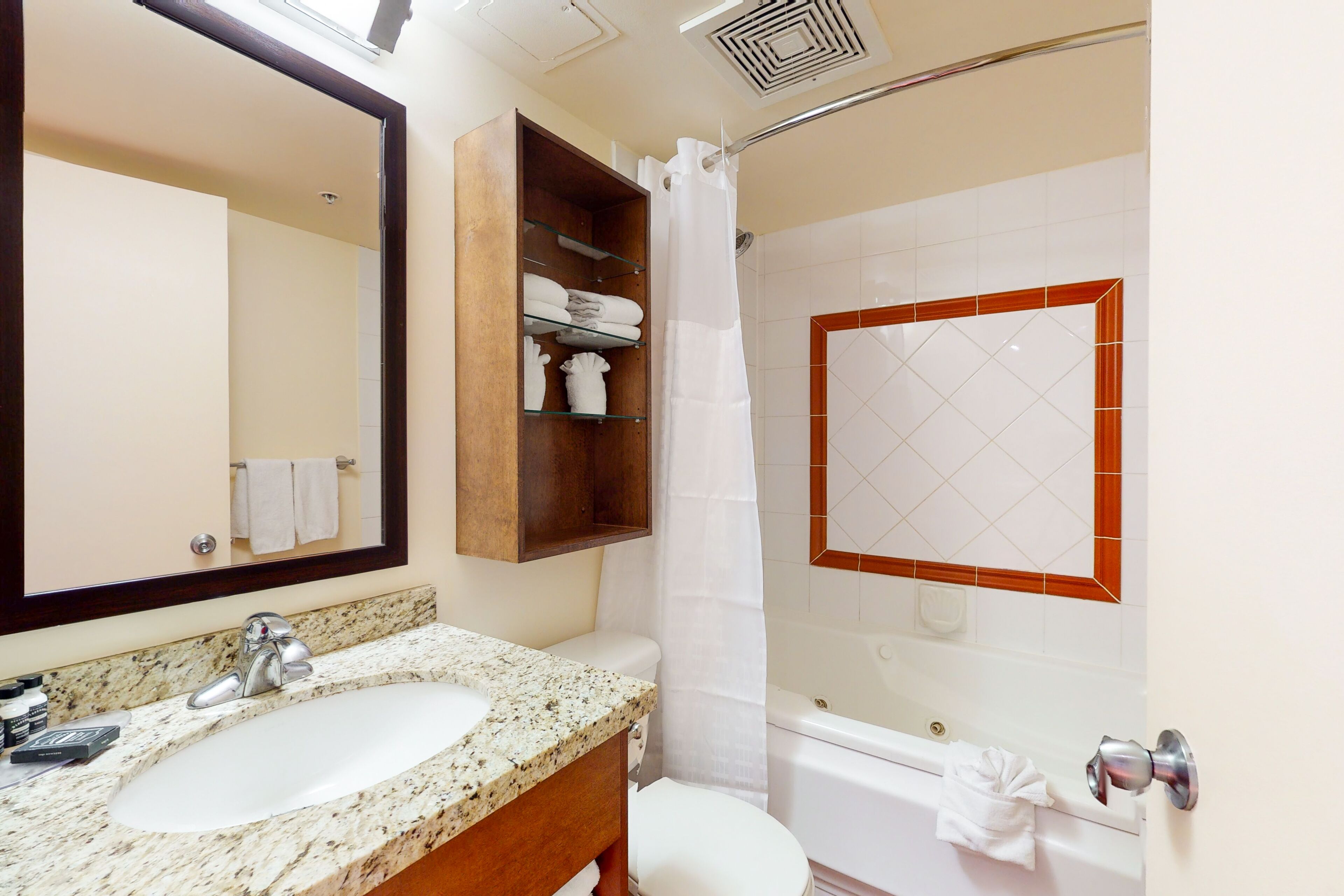 A bathroom with a sink, mirror, shower, and bathtub.