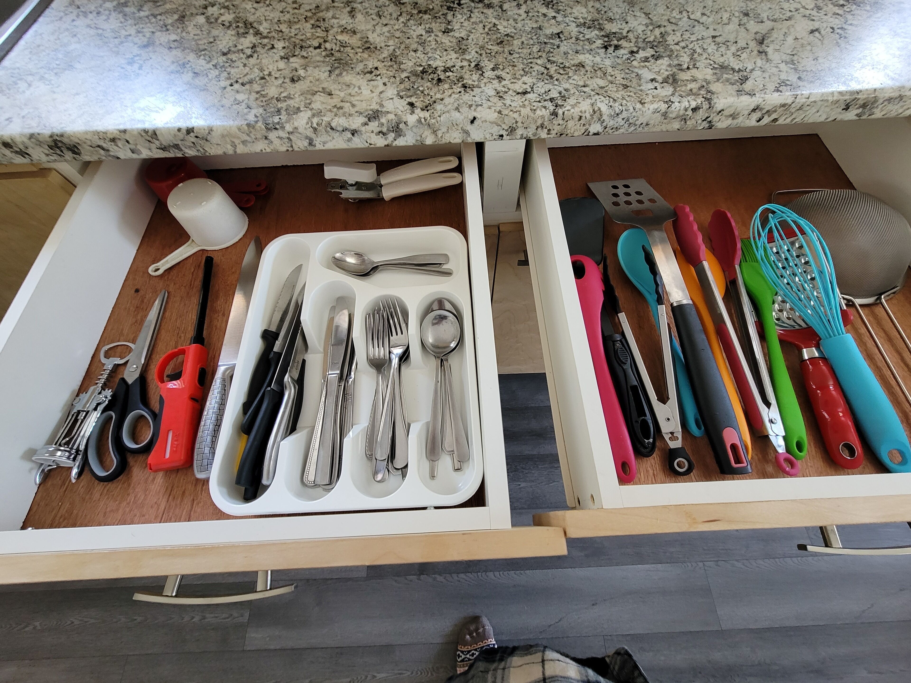 A kitchen drawer with utensils and kitchen tools.