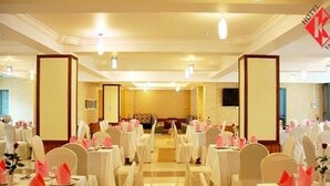 A hotel banquet hall with tables set for events, featuring a central aisle and mirrored walls. - Hotel K Yangon (Yangon)