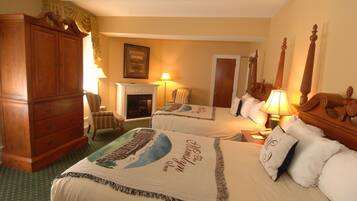 A hotel room with two beds, a wooden wardrobe, a chair, a fireplace, and a lamp.