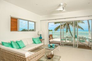 2 Bedroom Beachfront Villa | Living area | 60-inch flat-screen TV with satellite channels, LED TV, iPod dock