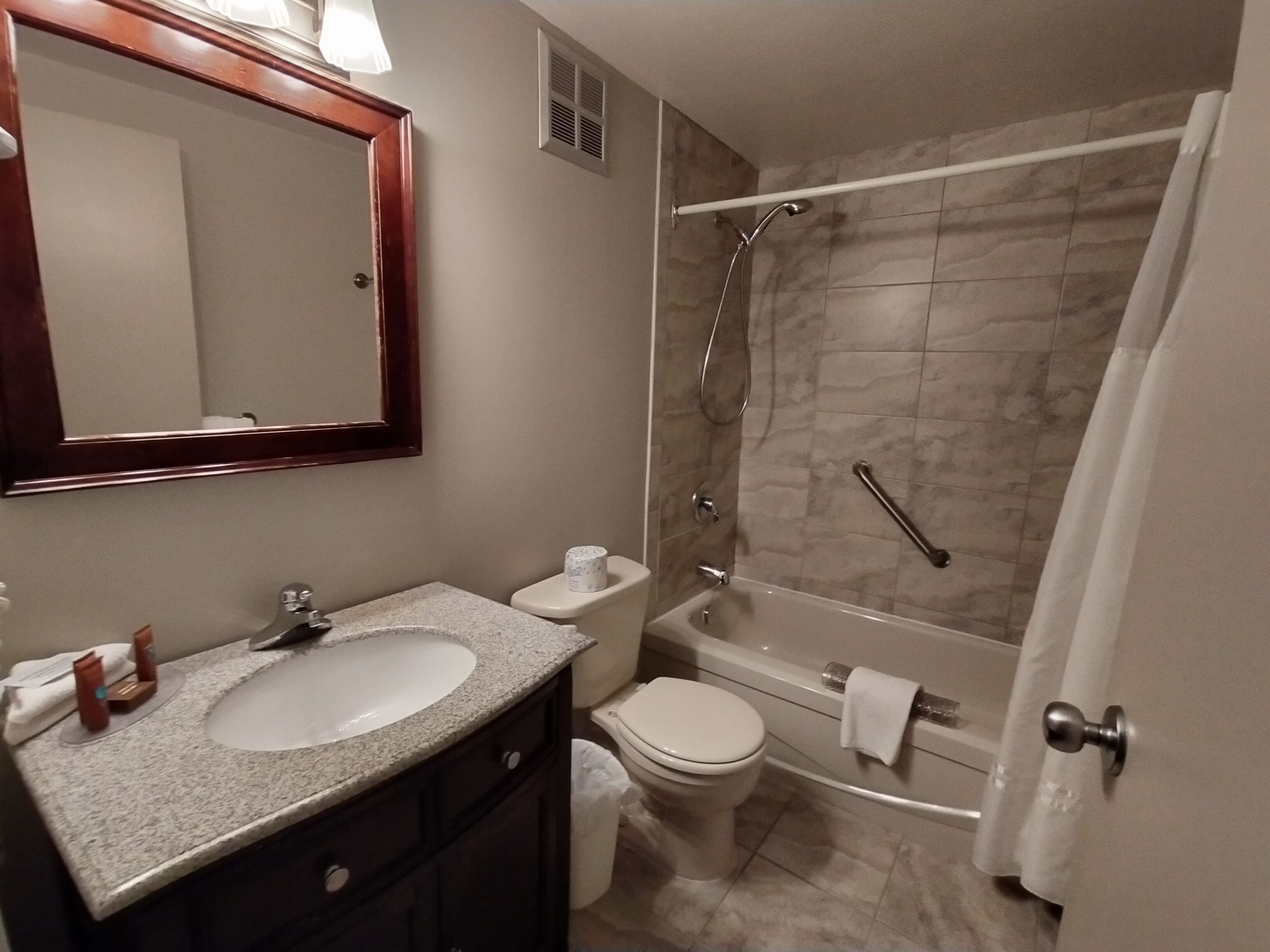 A bathroom with a sink, toilet, and shower.