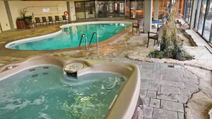 An indoor swimming pool with a hot tub and lounge chairs. - Royal Harbour Resort (The Blue Mountains)