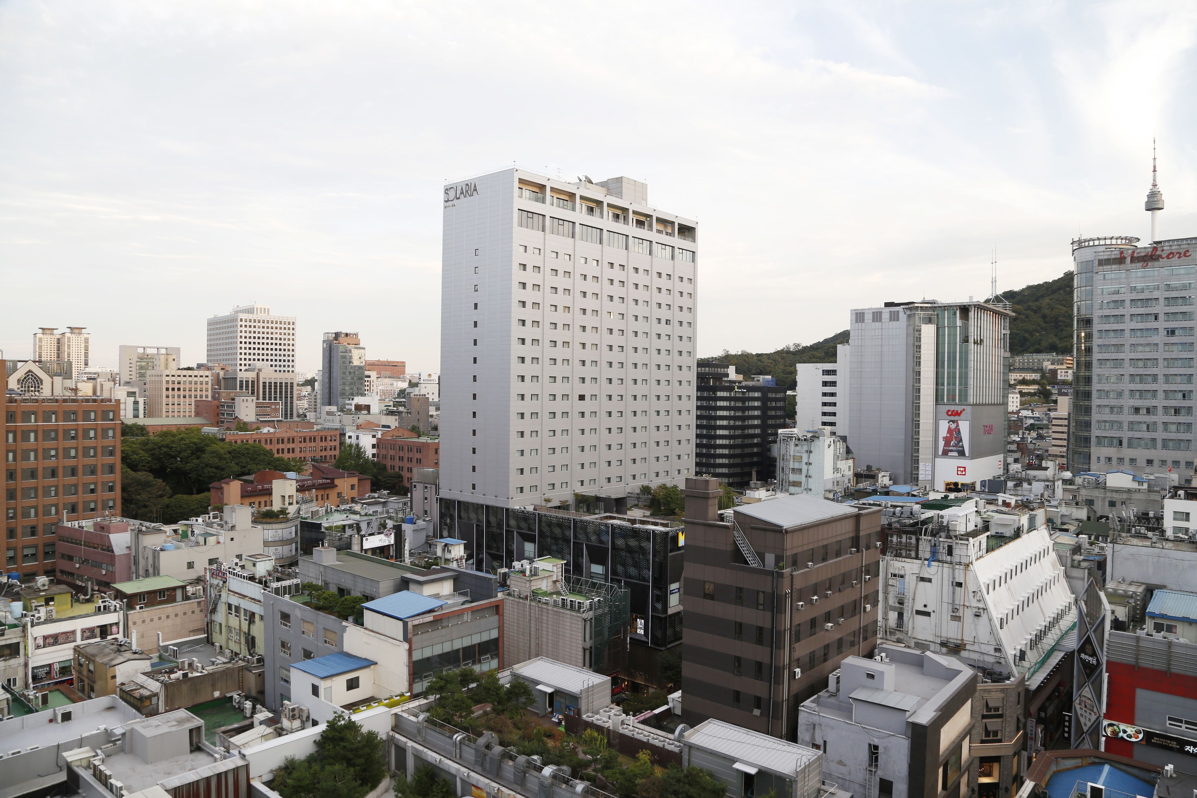 A high-rise hotel with a modern design, multiple floors, and a prominent entrance.