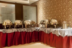 Un buffet composé de plusieurs présentoirs, chacun étant surmonté d’un couvercle en forme de dôme et muni d’un plateau en argent.