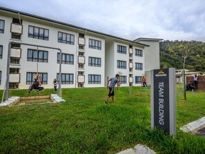 A building with multiple windows and a sign labeled "TEAM BUILDING".