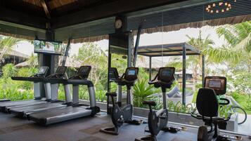A gym with treadmills, stationary bikes, and elliptical machines.