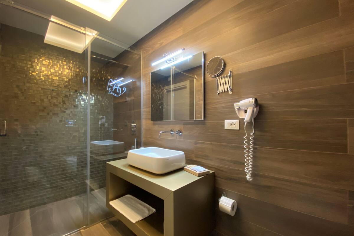 deluxe room (king) | bathroom | shower, designer toiletries, hair dryer, bathrobes