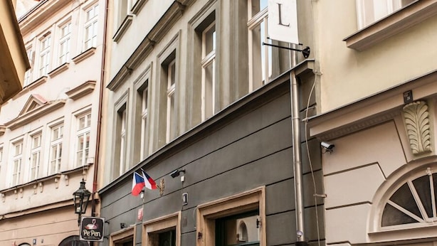 A hotel with a sign reading "HOTEL" on a building facade.