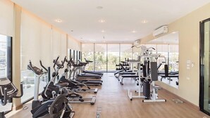 A gym with treadmills, elliptical machines, and weight machines. - The Trust Huahin Condo Garden View by Dome (Hua Hin)
