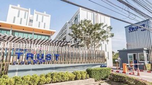 A modern building with a sign that reads "The Trust." - The Trust Huahin Condo Pool View by Dome (Hua Hin)