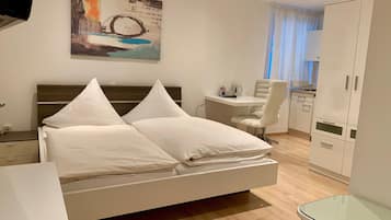 Premium bedding, desk, laptop workspace, blackout drapes