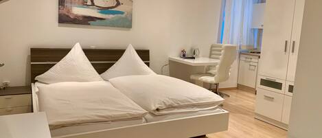 Premium bedding, desk, laptop workspace, blackout curtains