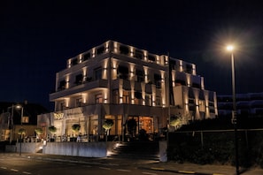 A multi-story building with a ground-level restaurant and a visible staircase leading to the entrance. - Vesper Hotel (Noordwijk)